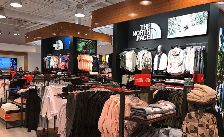 Dedicated The North Face branded retail section featuring jackets, apparel racks, and product displays.