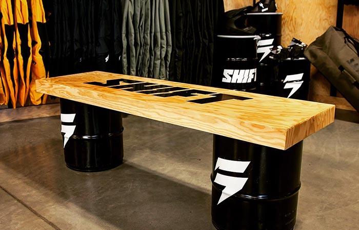 Custom point-of-sale display with branded barrels and signage, designed by 54blue to enhance in-store retail presence.