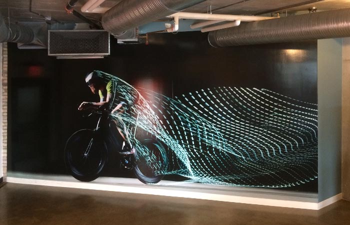In-store illuminated lightbox display with futuristic visual, representing 54blue’s in-store graphic printing solutions.